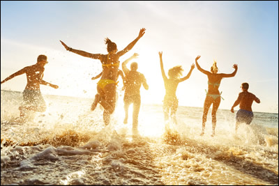 People entering the surf at the beach