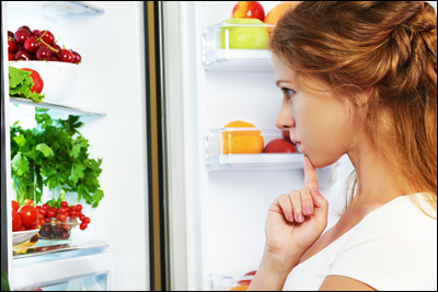 Woman looking in refrigerator