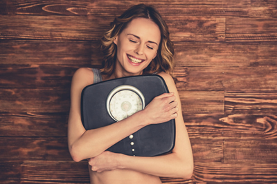 Woman hugging scales