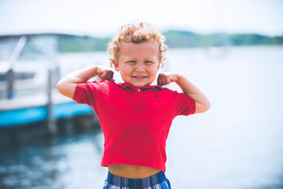 Child flexing muscles