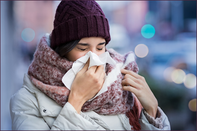 Woman blowing nose