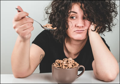 Woman staring at cereal