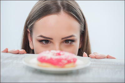 Woman Staring at Doughnut