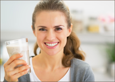 Smiling woman holding shake